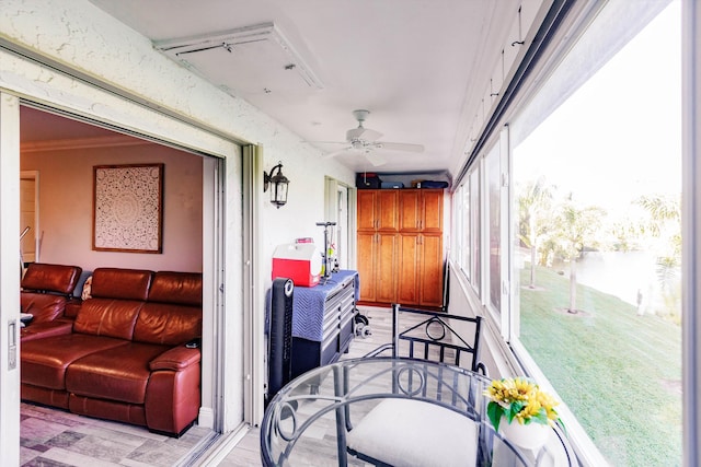 sunroom featuring a ceiling fan