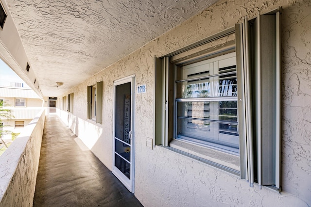 property entrance with stucco siding and a balcony