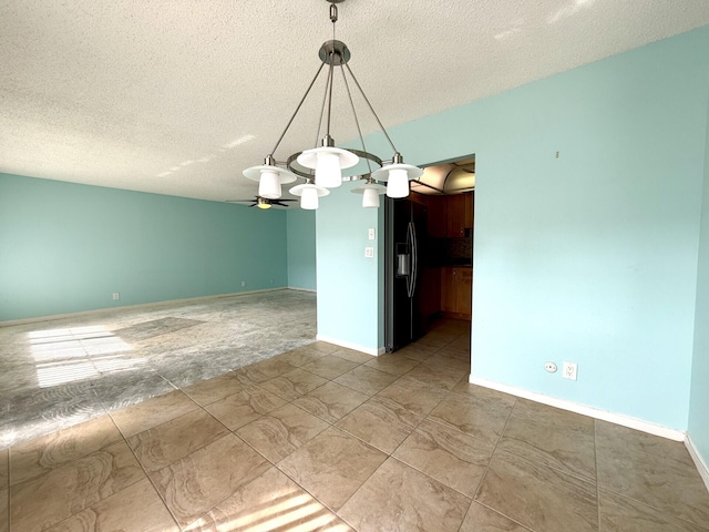 unfurnished room featuring ceiling fan and a textured ceiling