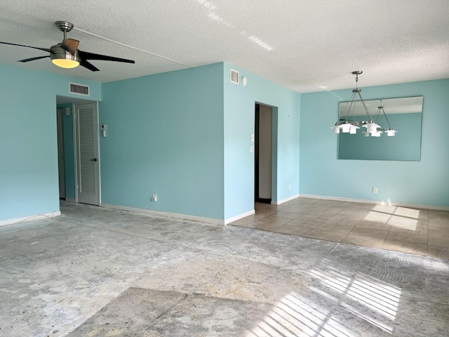 empty room featuring ceiling fan and a textured ceiling