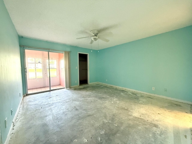 spare room with concrete flooring, a textured ceiling, and ceiling fan