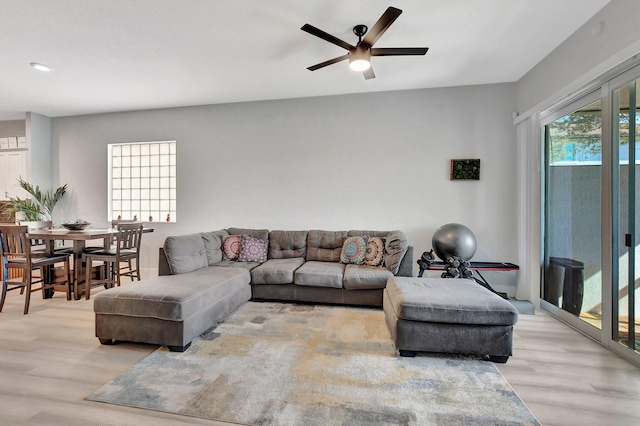 living room featuring light hardwood / wood-style floors and ceiling fan