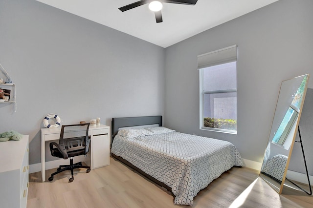 bedroom with ceiling fan and light hardwood / wood-style floors