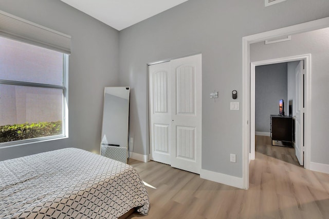 bedroom featuring a closet and light hardwood / wood-style floors