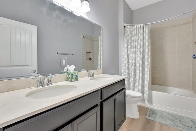 full bathroom with toilet, shower / tub combo, hardwood / wood-style flooring, and vanity