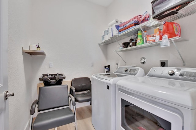 laundry area with light wood-type flooring and independent washer and dryer