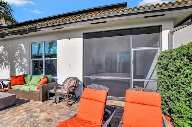 rear view of property featuring outdoor lounge area and a patio