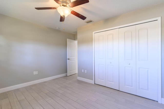 unfurnished bedroom with light wood-type flooring, a closet, and ceiling fan