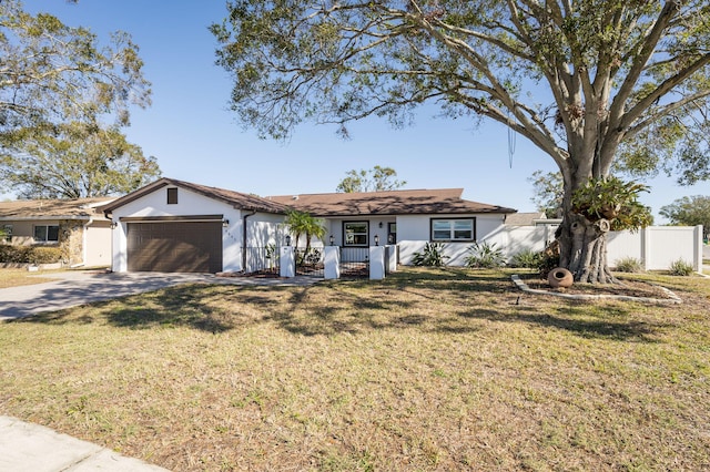 single story home featuring a front lawn and a garage