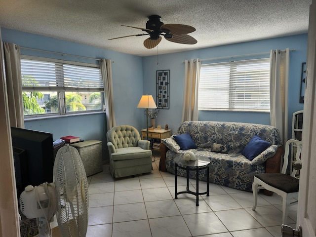 tiled living room with ceiling fan and a textured ceiling