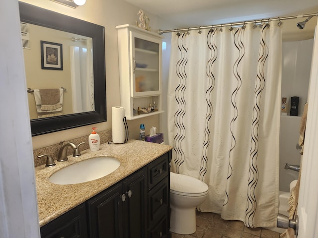 full bathroom featuring shower / bathtub combination with curtain, tile patterned flooring, vanity, and toilet