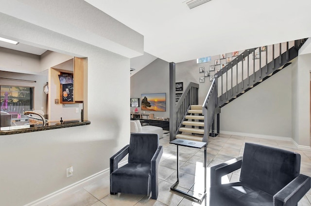 living area featuring plenty of natural light, light tile patterned floors, and vaulted ceiling