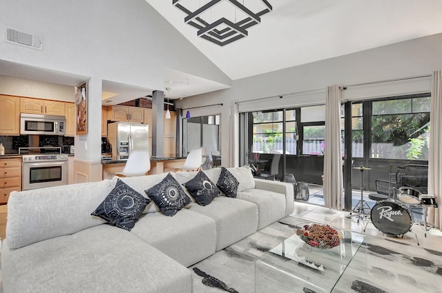 living room with high vaulted ceiling