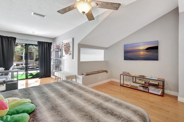 bedroom featuring a textured ceiling, access to outside, ceiling fan, wood-type flooring, and lofted ceiling