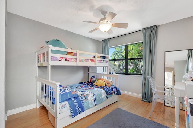 bedroom featuring a textured ceiling, hardwood / wood-style flooring, and ceiling fan