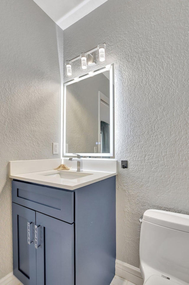 bathroom with vanity and toilet