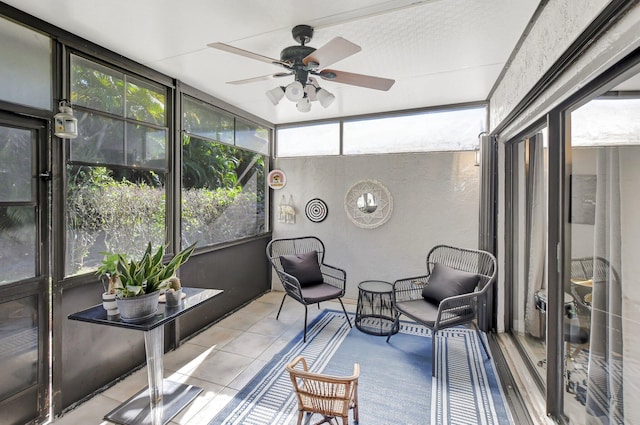 sunroom / solarium featuring ceiling fan