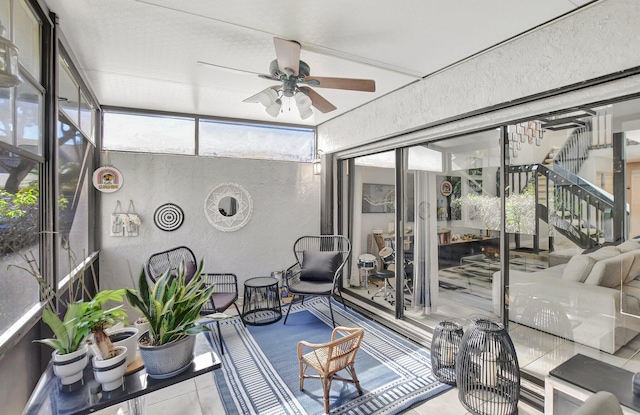 sunroom / solarium featuring ceiling fan