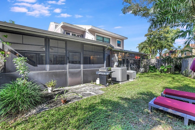 view of yard with a sunroom and cooling unit