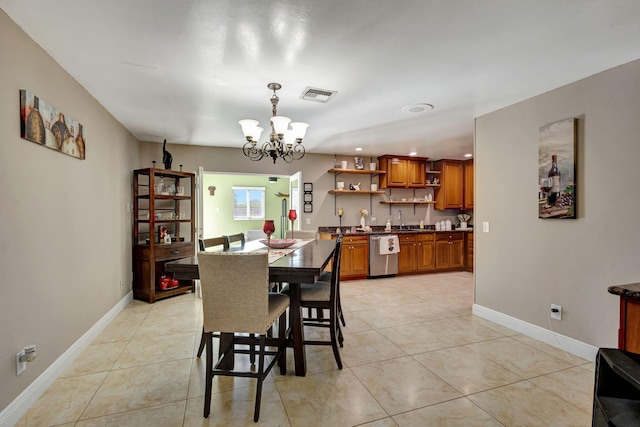 dining area with light tile patterned flooring, sink, and an inviting chandelier