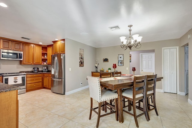 tiled dining area featuring a notable chandelier