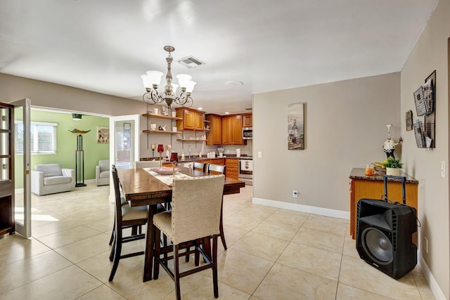 dining room featuring an inviting chandelier and light tile patterned flooring