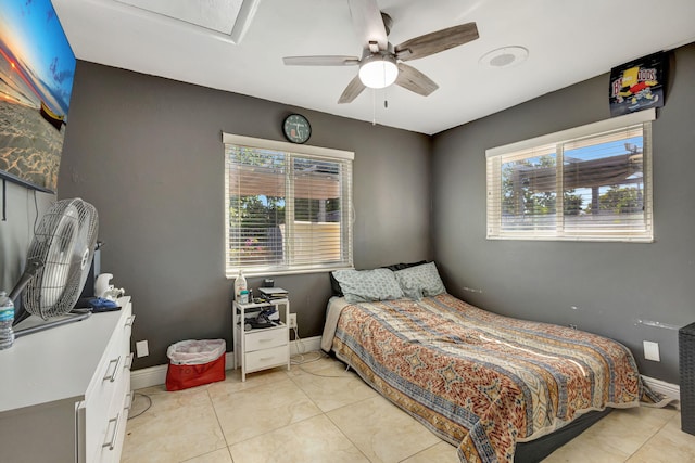 bedroom with ceiling fan and light tile patterned flooring