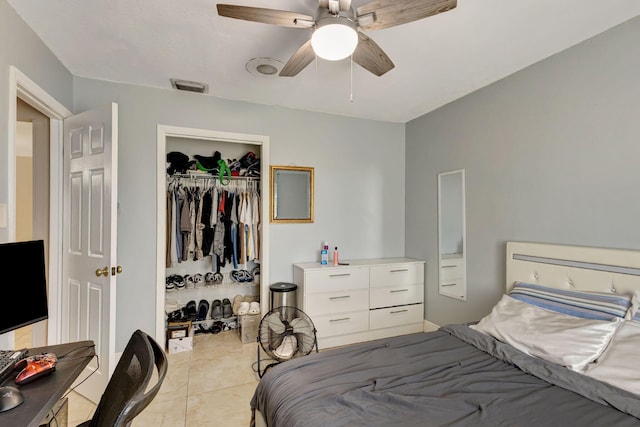 bedroom featuring ceiling fan, a closet, and light tile patterned flooring