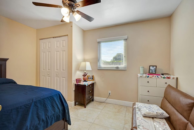 tiled bedroom featuring ceiling fan and a closet