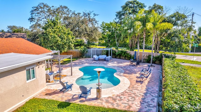 view of swimming pool featuring a patio and a pergola