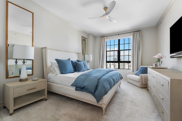 carpeted bedroom featuring ceiling fan and crown molding