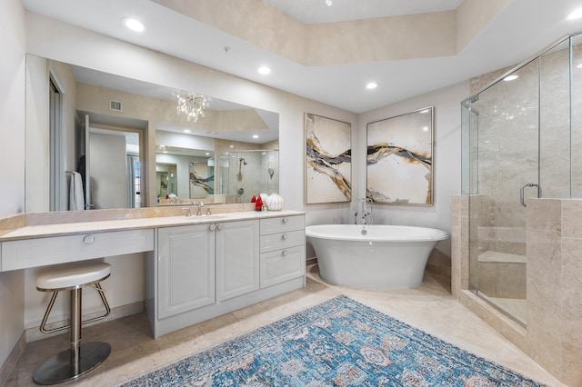 bathroom featuring separate shower and tub, vanity, and a notable chandelier