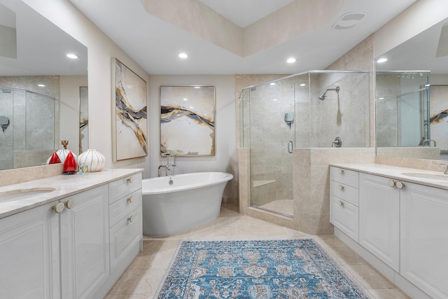 bathroom with vanity and separate shower and tub