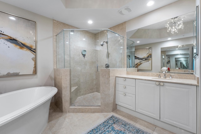 bathroom featuring vanity, plus walk in shower, and a chandelier