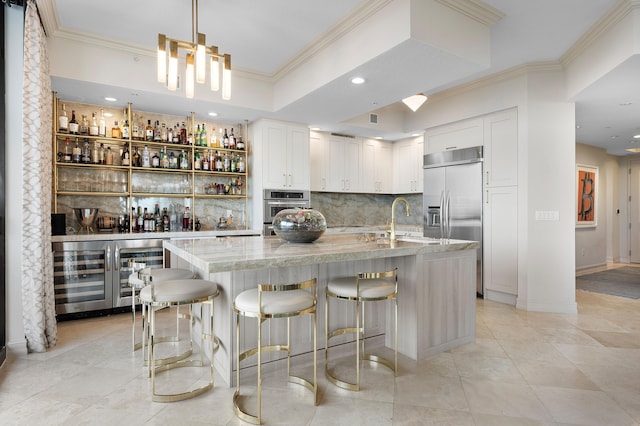 bar with white cabinetry, wine cooler, light stone counters, pendant lighting, and appliances with stainless steel finishes