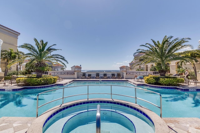 view of swimming pool with a community hot tub