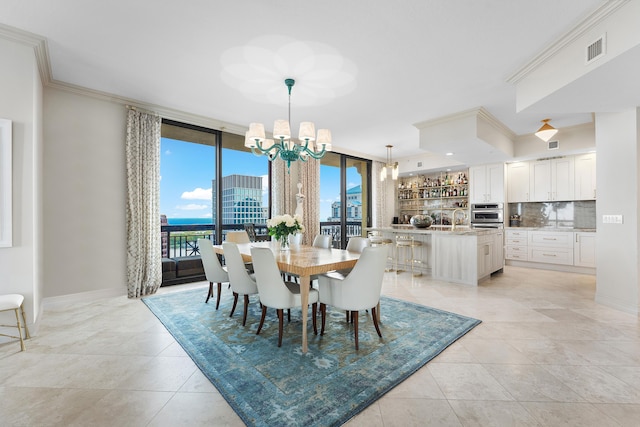 tiled dining area with sink, a wall of windows, crown molding, and an inviting chandelier