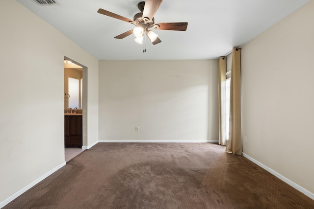 carpeted spare room with ceiling fan