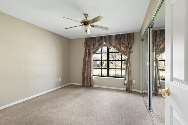 spare room with light carpet and ceiling fan