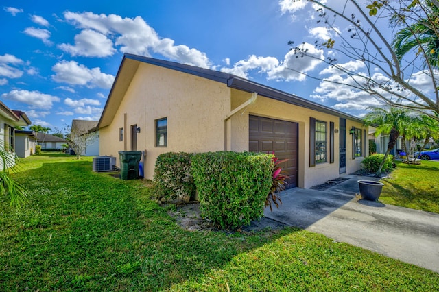 view of home's exterior with a yard, a garage, and central AC unit