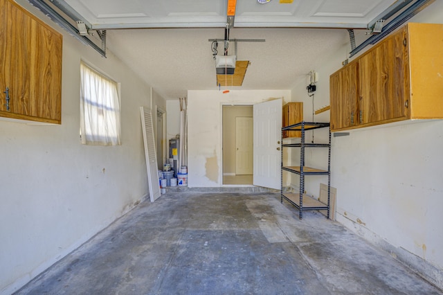 garage featuring electric water heater and a garage door opener