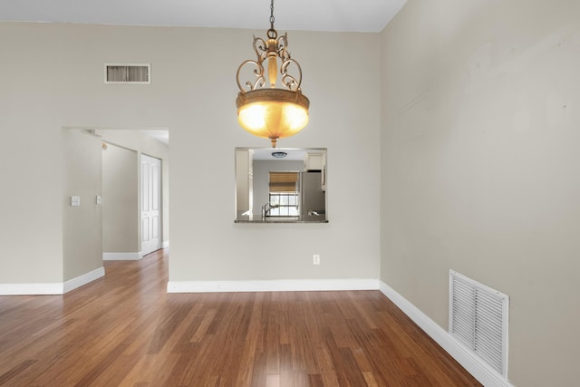 interior space with hardwood / wood-style floors and an inviting chandelier