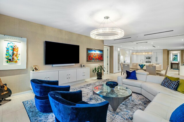 living room with baseboards and an inviting chandelier