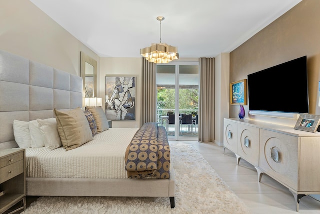 bedroom featuring light wood-type flooring, access to outside, and a notable chandelier