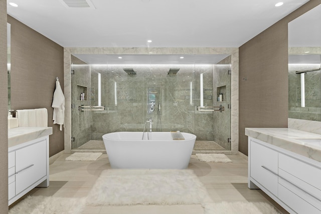 bathroom with shower with separate bathtub, tile walls, and vanity