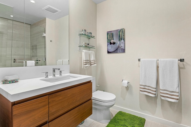 bathroom with a shower stall, visible vents, toilet, and vanity