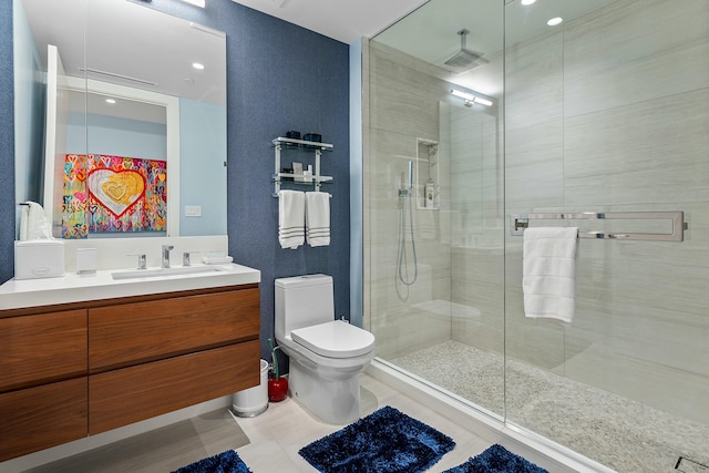 bathroom with a shower stall, toilet, and vanity