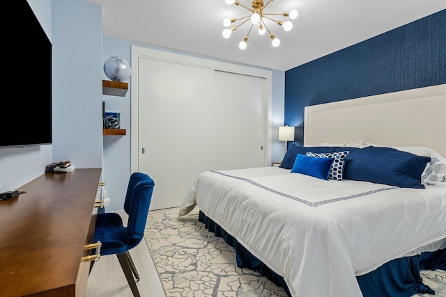 bedroom featuring an inviting chandelier and a closet