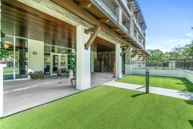 rear view of house with a patio area and a lawn