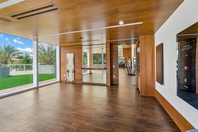 spare room with a wall of windows, wood ceiling, and dark hardwood / wood-style floors